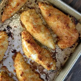 baked parmesan chicken tenders on a baking sheet