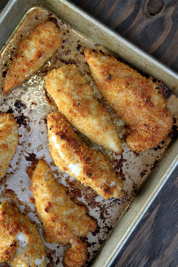 baked parmesan chicken tenders on a baking sheet