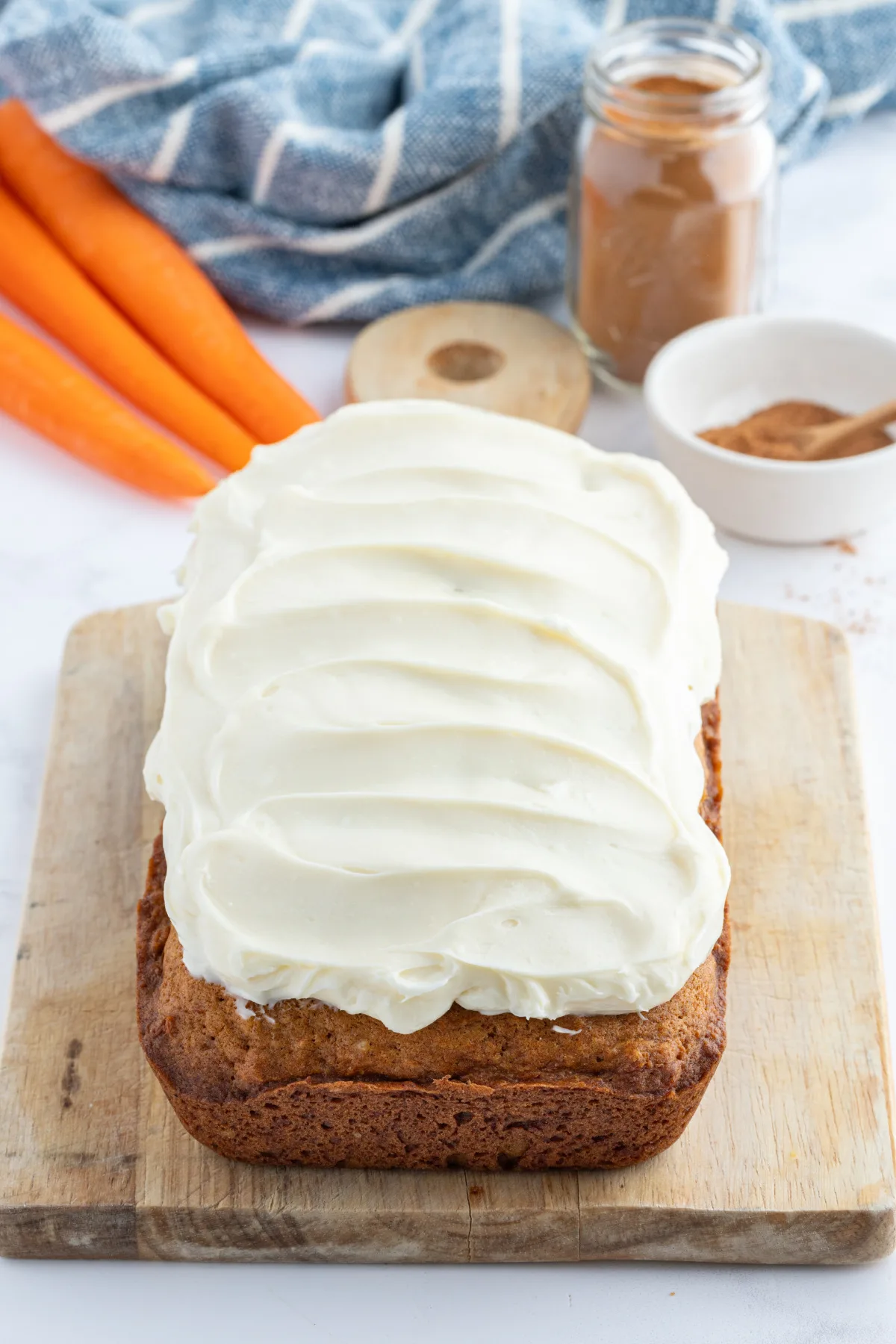carrot loaf cake frosted on board
