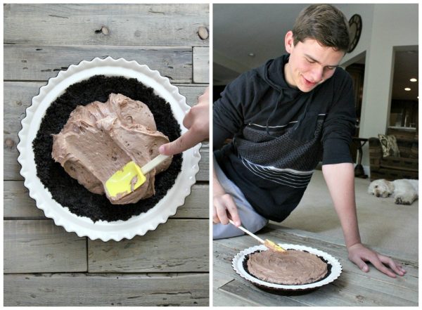 two photo collage showing how to make a nutella pie. The first photo shows the filling being spread into the chocolate pie crust in a white pie plate, and the second photo shows a little boy spreading the filling evenly into the pie plate