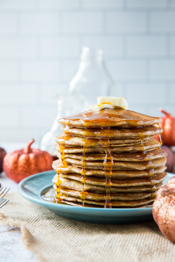 stack of pumpkin pancakes with maple syrup