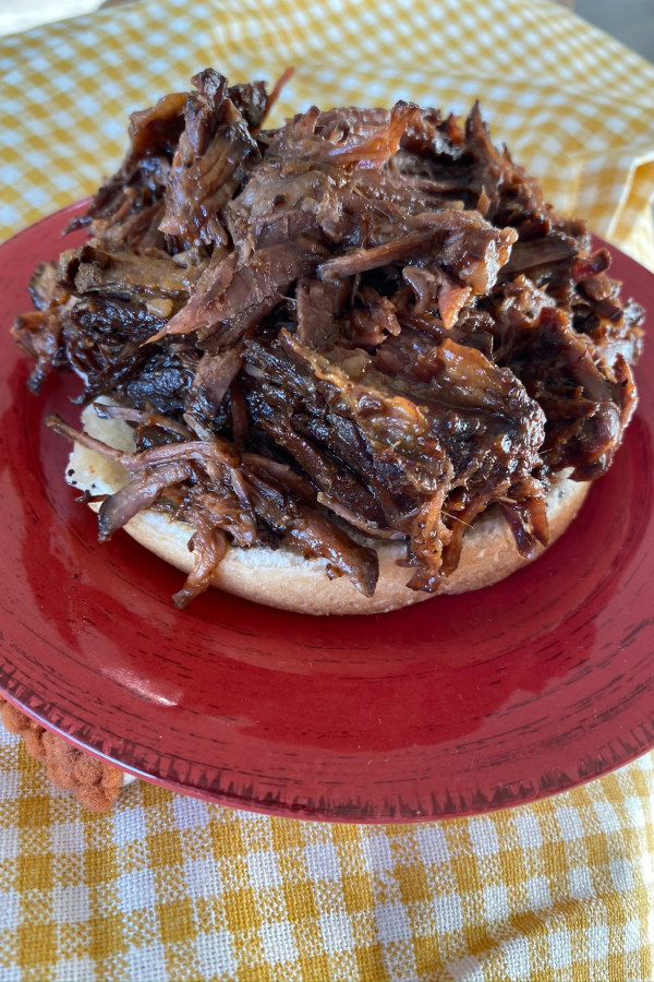 Adding beef to the buns for Tex Mex Shredded Beef Sandwiches