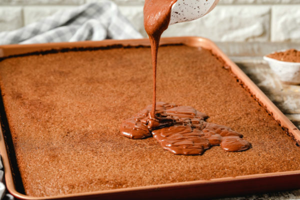 Adding frosting to Texas Sheet Cake