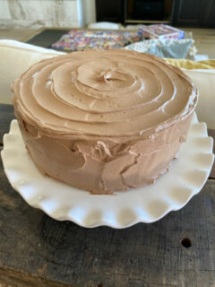 chocolate cake sitting on a white platter