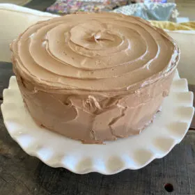 chocolate cake sitting on a white platter