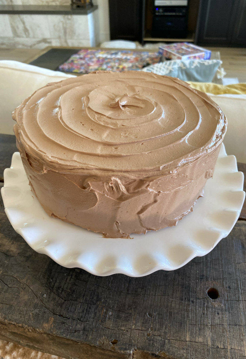 chocolate cake sitting on a white platter