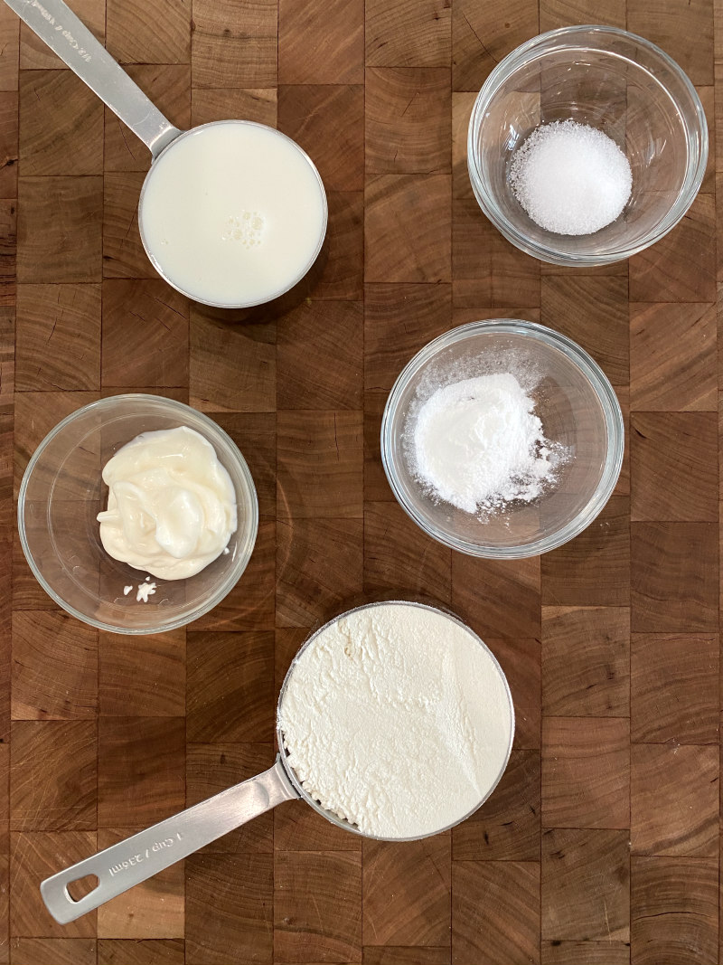 Ingredients for No Yeast Dinner Rolls placed on a cutting board