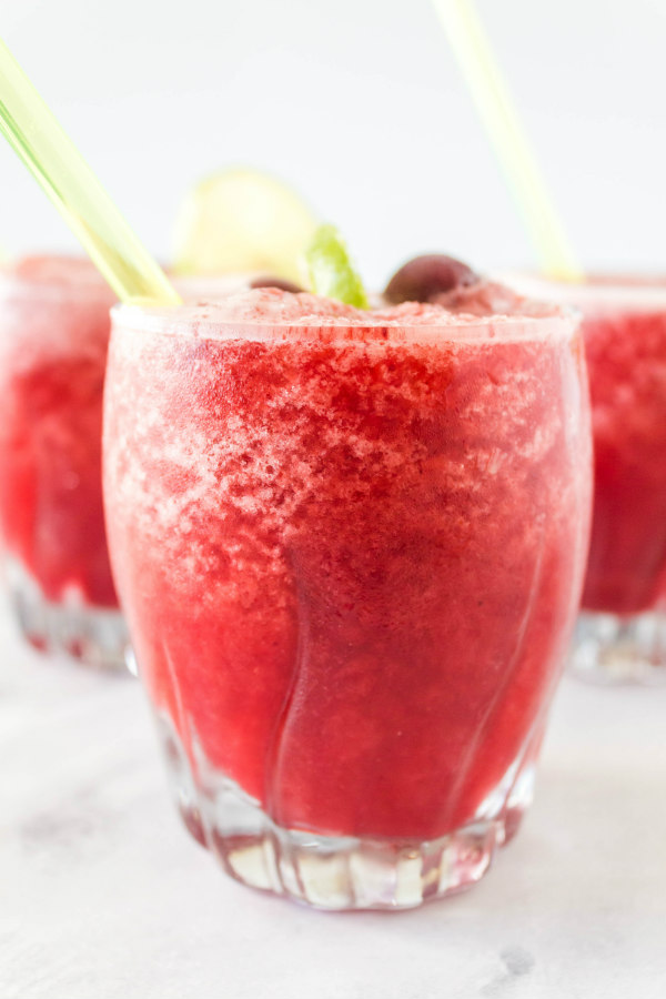 cherry lime slushies in glasses - 3 of them) with straws.