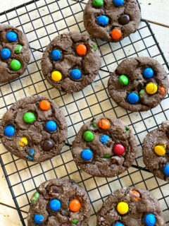 overhead shot of chocolate cake mix m&m cookies cooling on a cooling rack