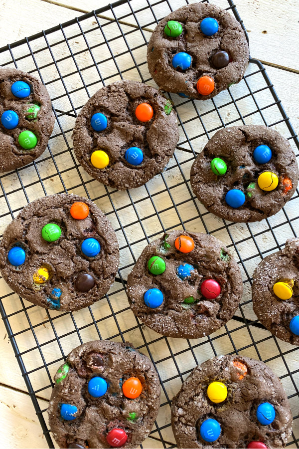 overhead shot of chocolate cake mix m&m cookies cooling on a cooling rack