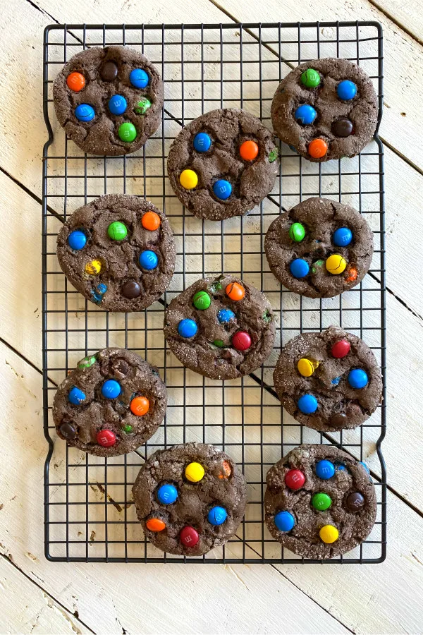 overhead shot of chocolate cake mix m&m cookies cooling on a cooling rack