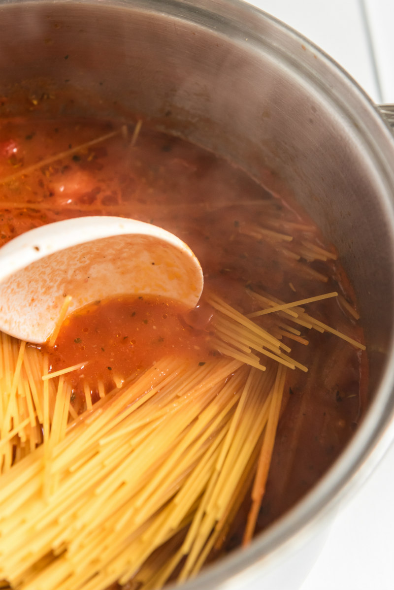 spaghetti being cooked in a pot