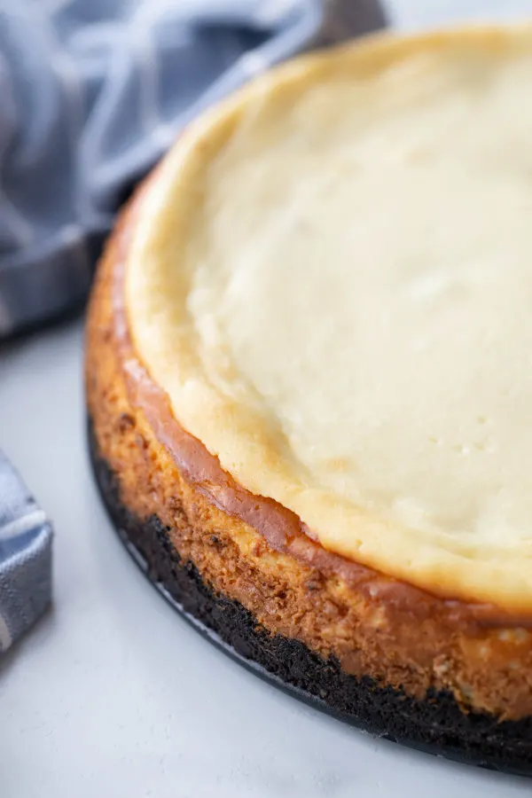 chocolate chip cookie dough cheesecake with a blue cloth napkin in the background