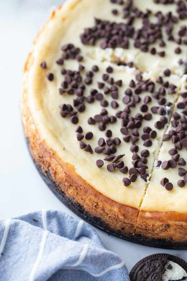 chocolate chip cookie dough cheesecake with a blue fabric napkin on the side