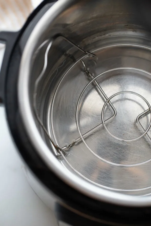 looking down into an instant pot with a insert inside and some water