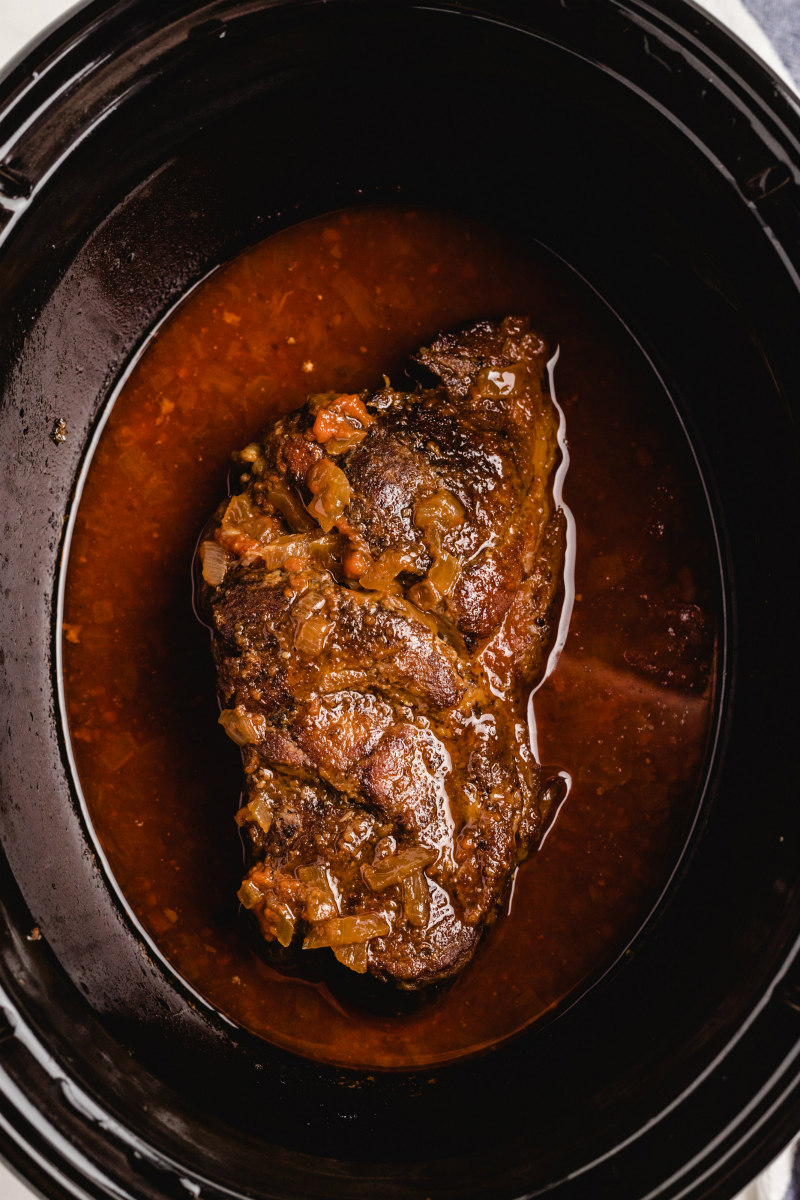 pork in a slow cooker cooked with sauce