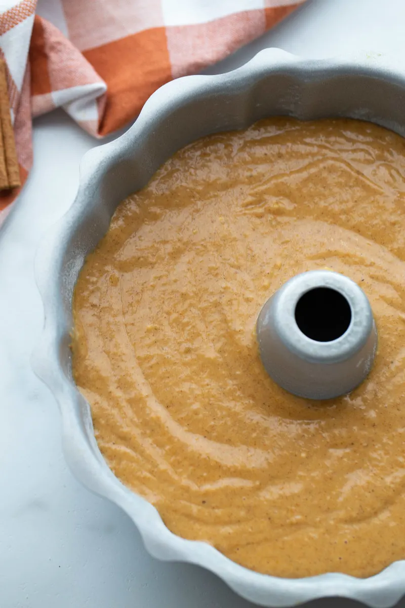 pumpkin batter in a bundt cake pan ready for oven