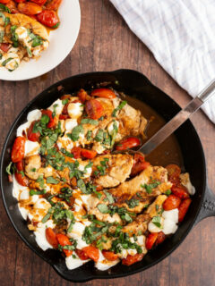 caprese chicken in a black skillet