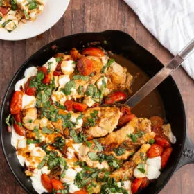 caprese chicken in a black skillet