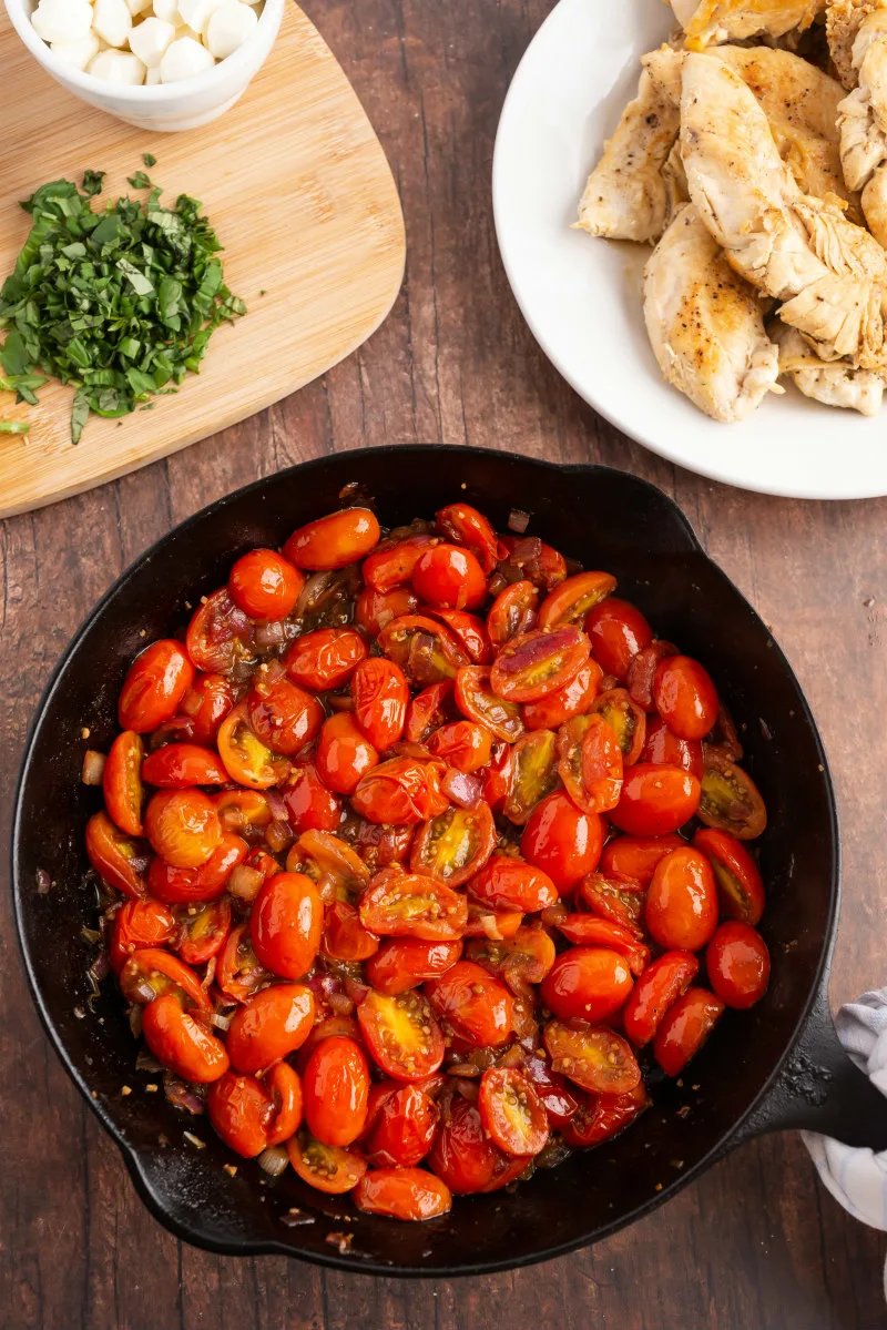 tomatoes cooking in cast iron black skillet