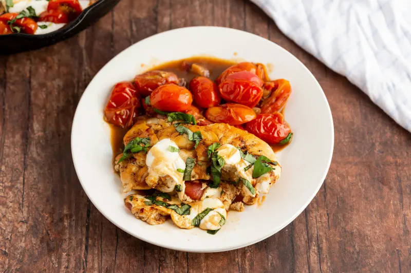 caprese chicken serving on white plate