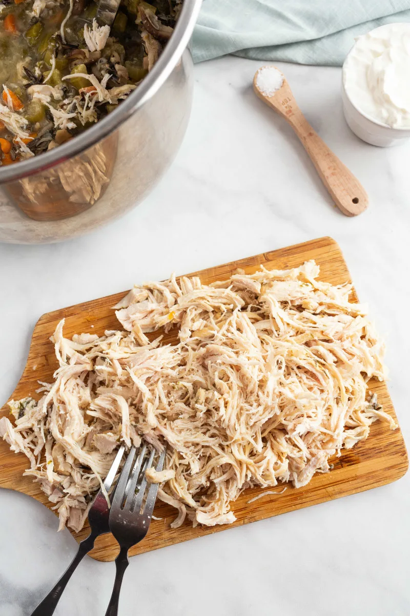 shredded chicken on a wood board