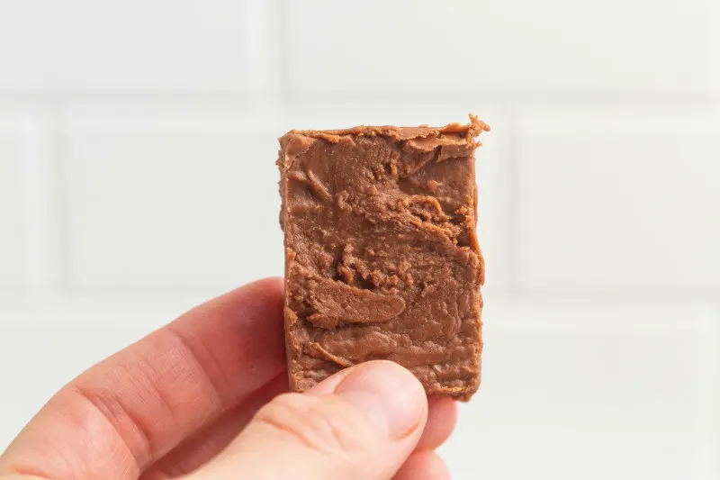 hand holding piece of fudge