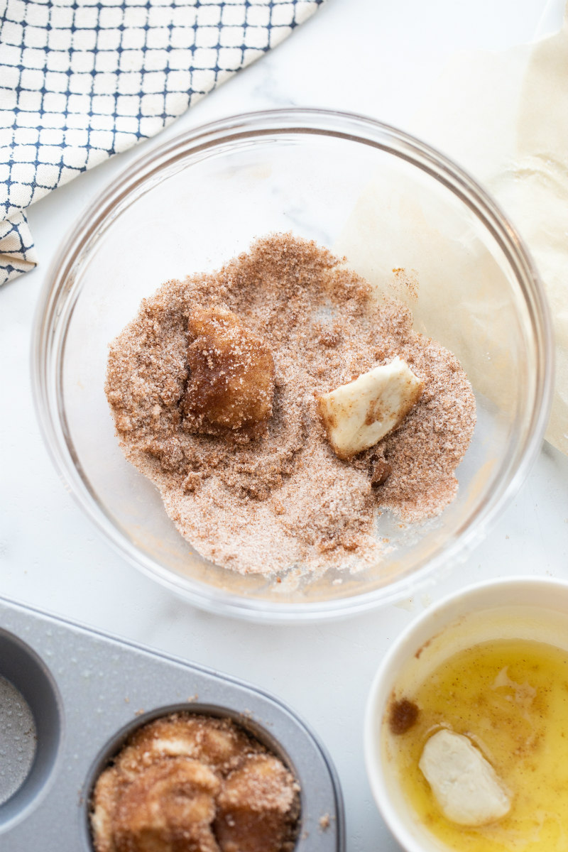 making monkey bread muffins in glass bowl