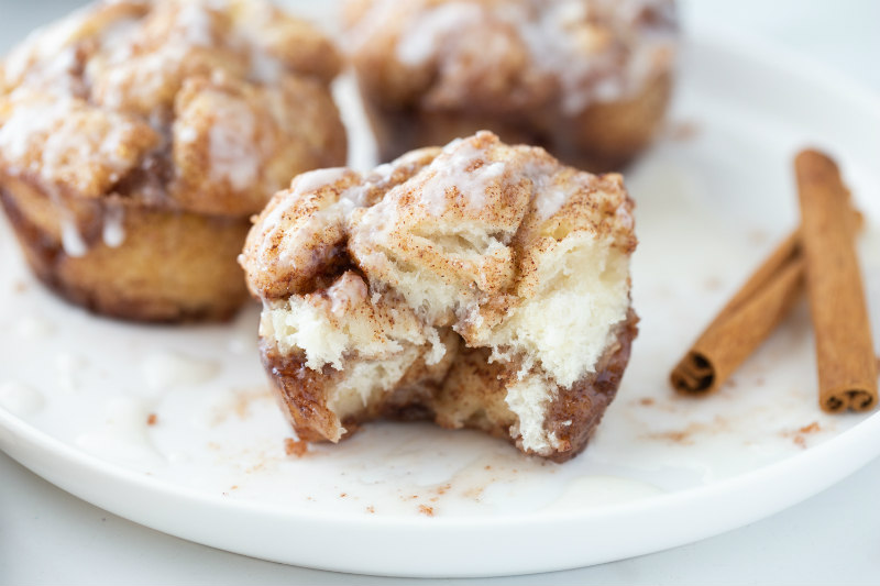 bite taken out of monkey bread muffin on white plate