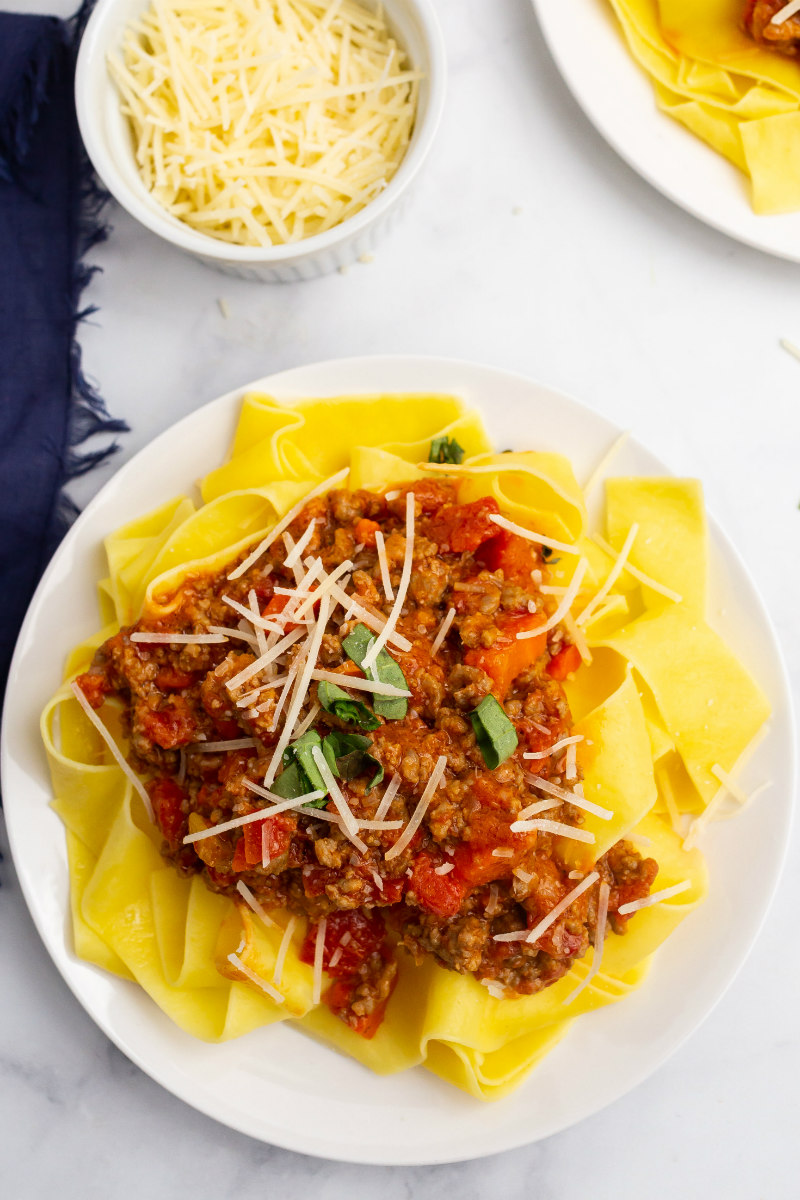 pappardelle bolognese on a white plate