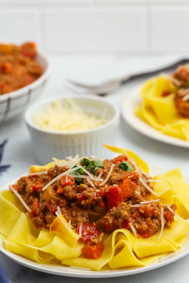 pappardelle bolognese on a white plate