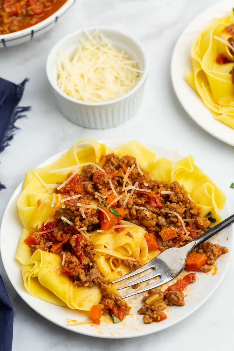 fork on plate of pappardelle bolognese