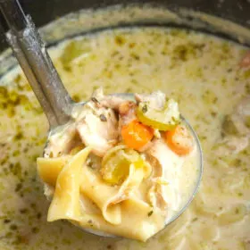 ladle full of turkey soup over pot