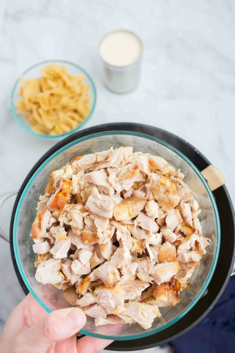 bowl of turkey being added to soup