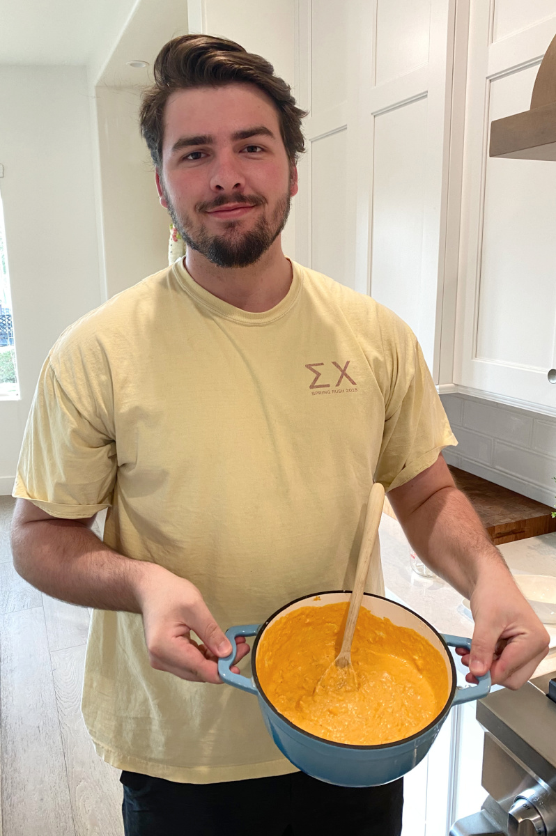 RecipeBoy holding pot of Buffalo Chicken Dip