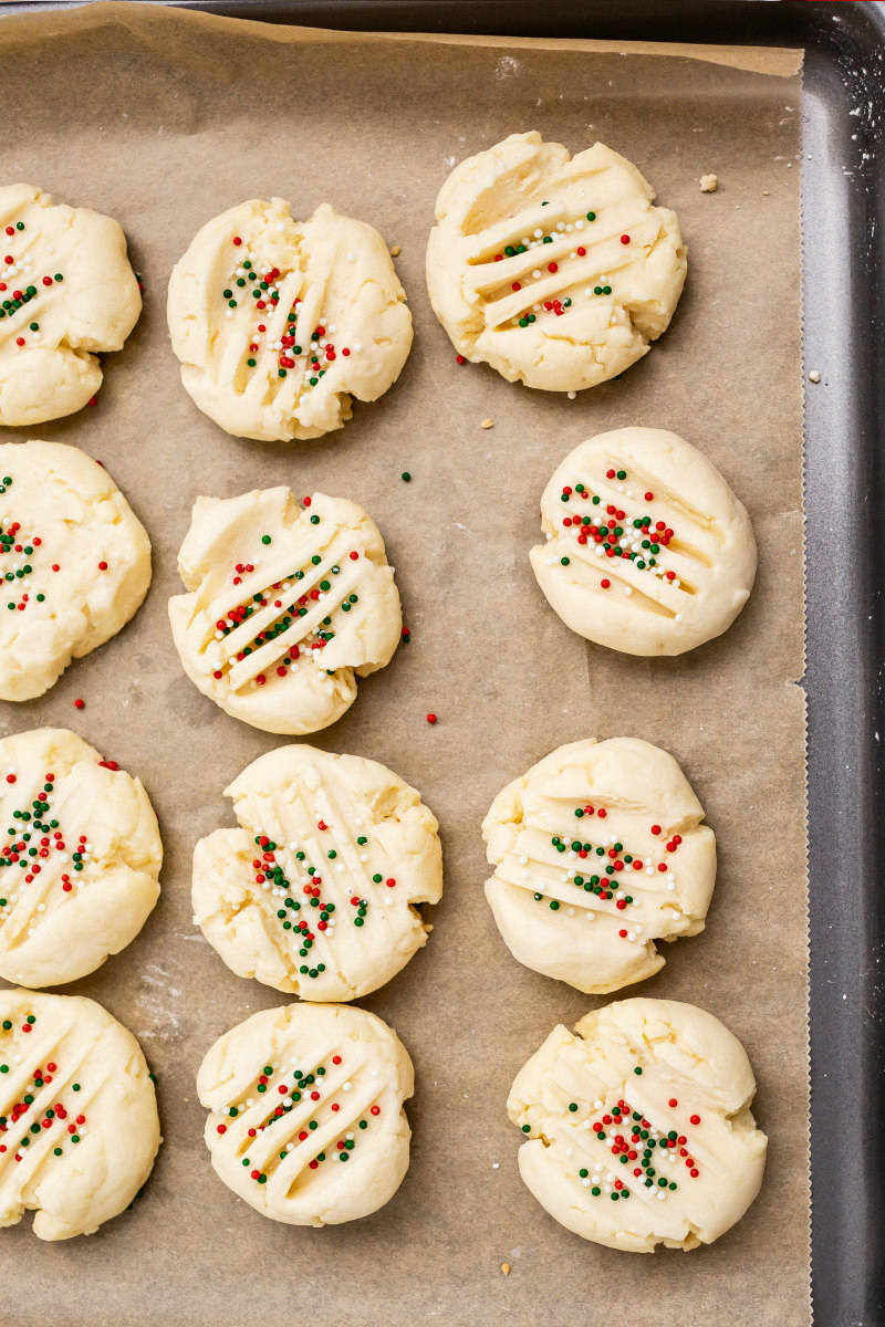 christmas shortbread cookies on a baking sheet ready for the oven
