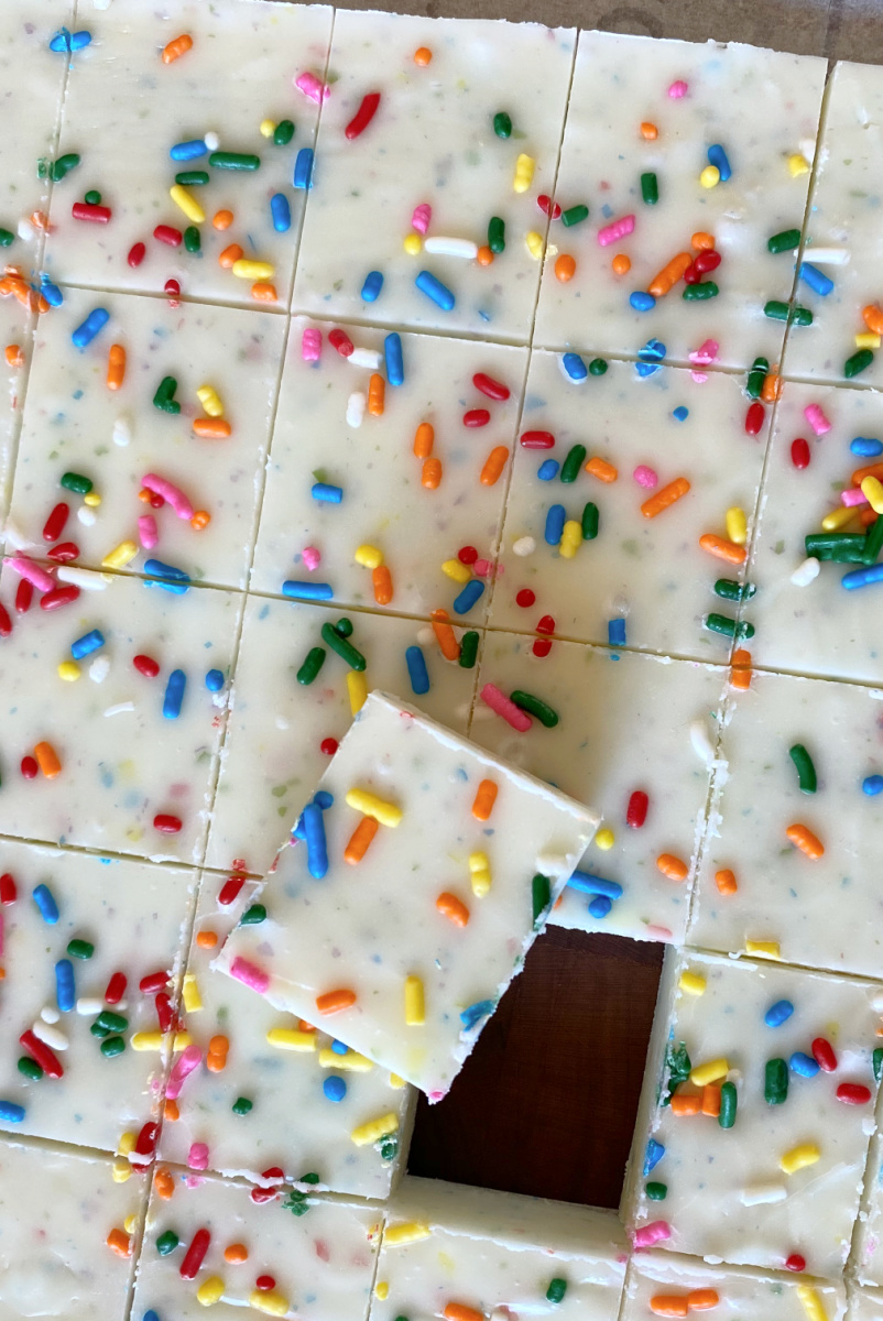 funfetti frosting fudge cut into pieces on cutting board