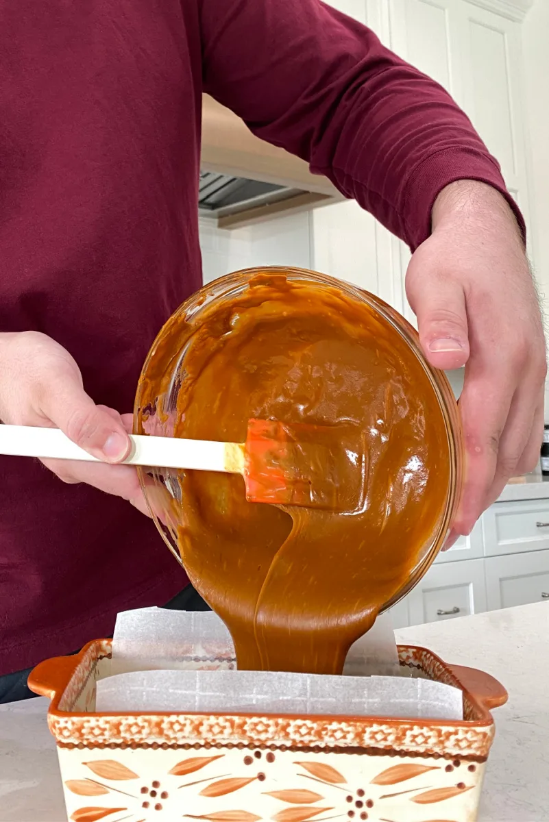 pouring cinnamon fudge into a pan