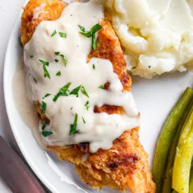 chicken fried chicken with gravy on top