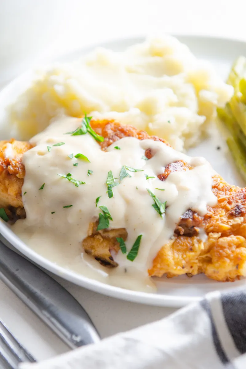 fried chicken covered with white gravy