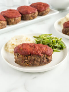 meatloaf on plate with potato and beans