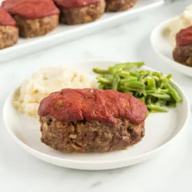 meatloaf on plate with potato and beans