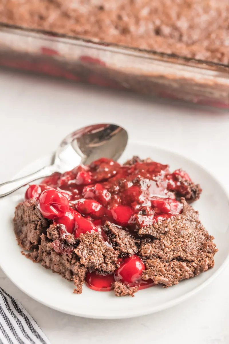 serving of chocolate cherry dump cake on a white dish
