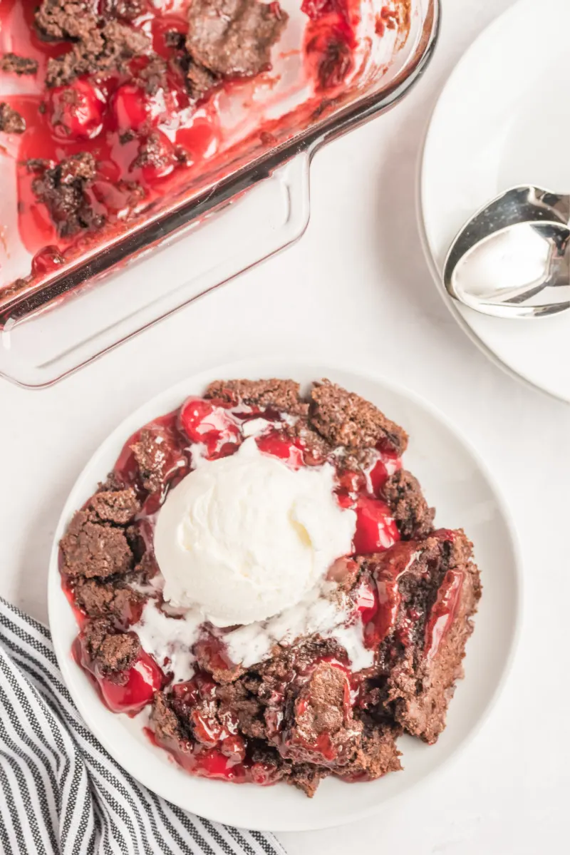serving of chocolate cherry dump cake with ice cream on top