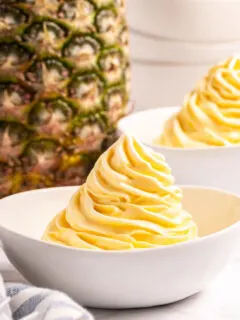 dole whip in a bowl with pineapple in background