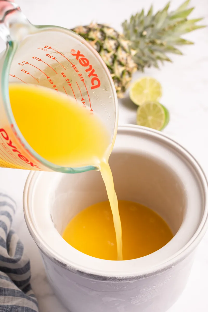 pouring base into ice cream maker to make dole whip