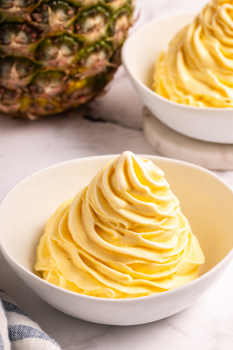 dole whip in a bowl with pineapple in background