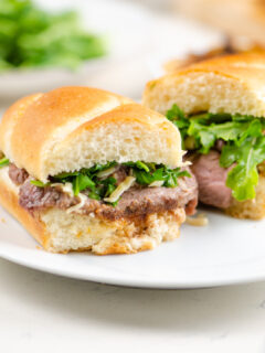 french onion steak sandwiches on white plate