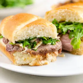 french onion steak sandwiches on white plate