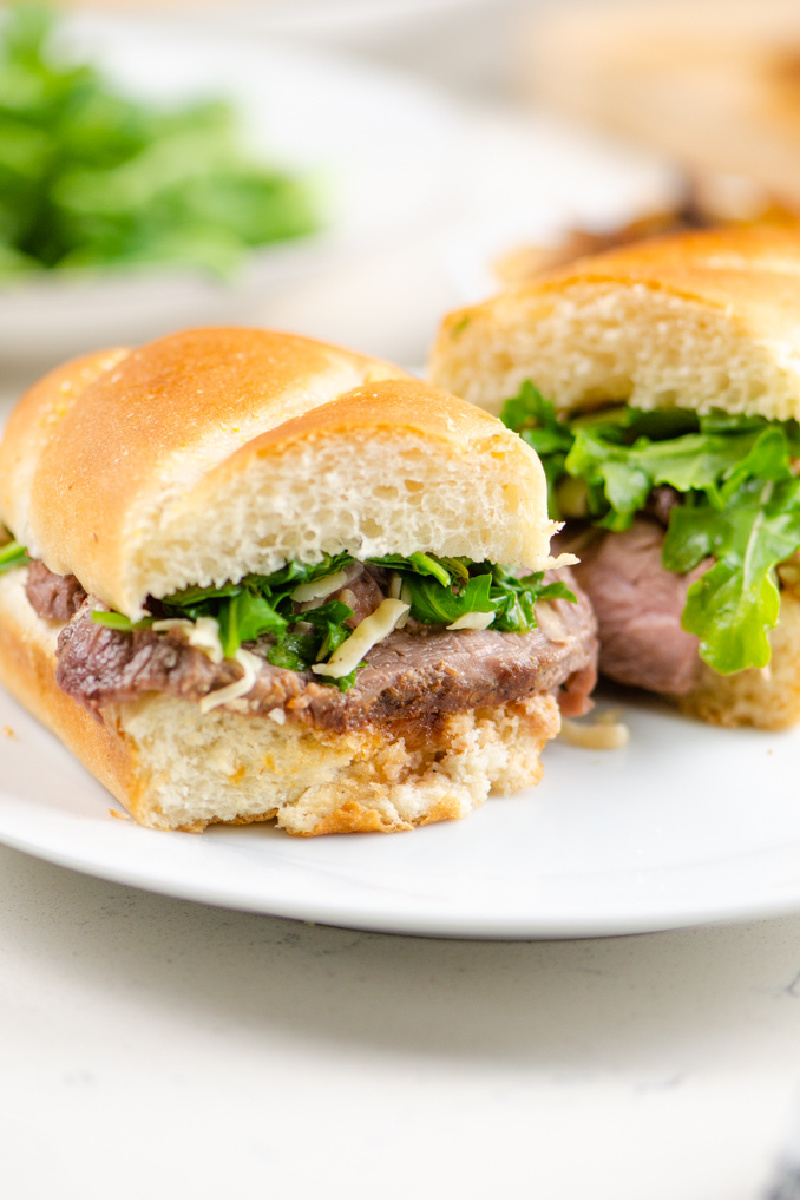 french onion steak sandwiches on white plate